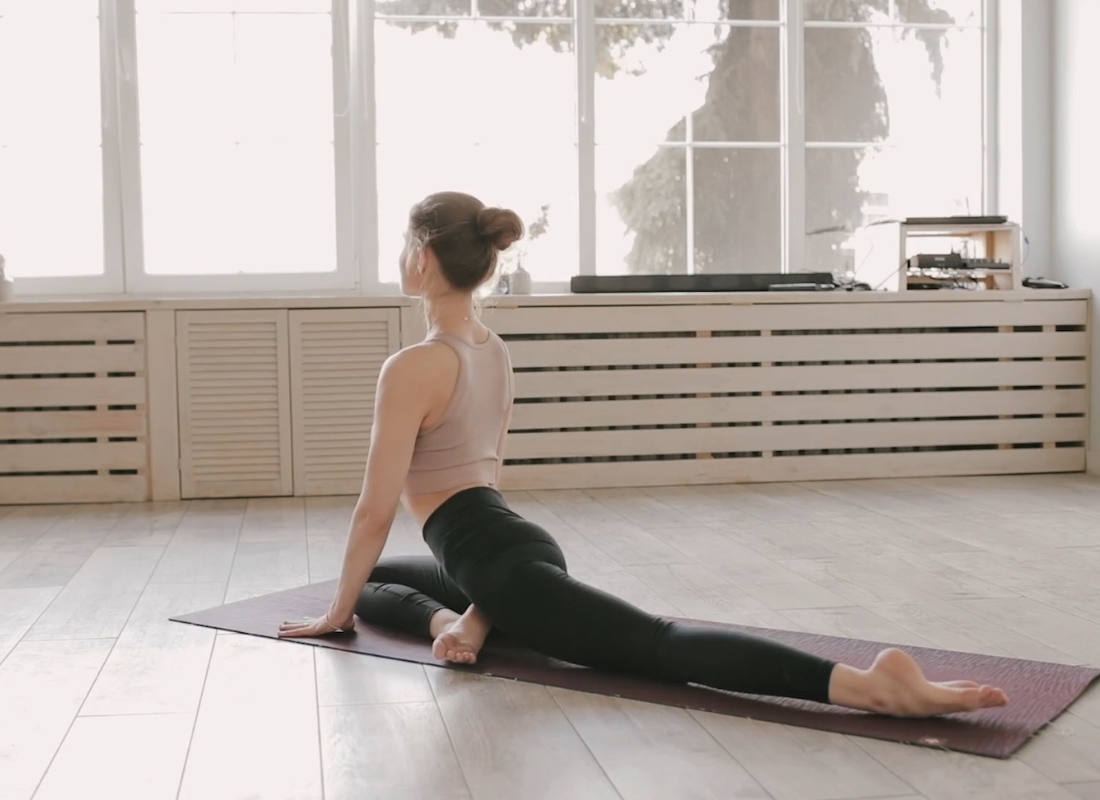 devojka radi vežbu joge na prostirci za jogu u svom domu